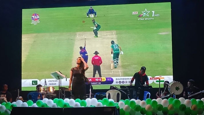 Indo-Pak match on the backdrop of Vijaya Sammelan stage, cheerful spectators