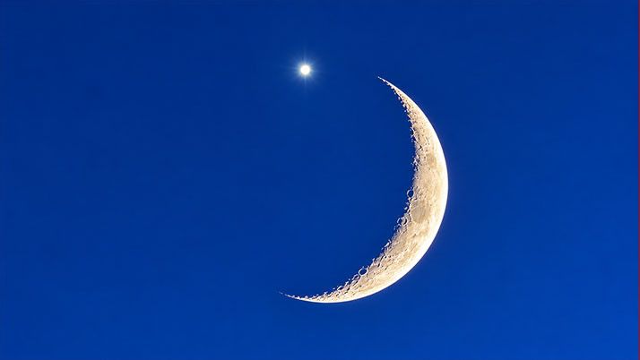 A bright point of light on the sliver of the moon! What a mystery in the evening sky!